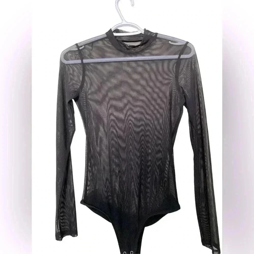 Source Unknown  black sheer bodysuit